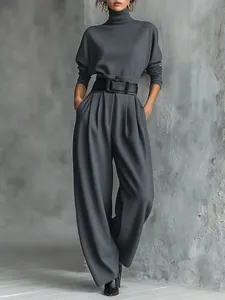 High neck long sleeve top with pleated wide leg trousers and black belt two-piece set.