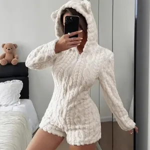 Detail of white plush hooded romper featuring bear ears and textured cable pattern