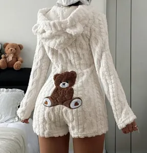 Back view of fuzzy white hooded romper featuring bear ears and a cute teddy bear patch