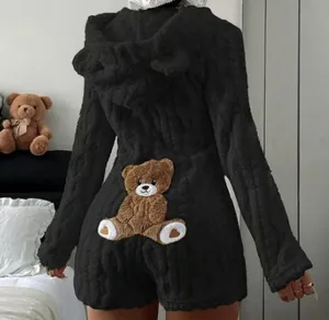 Detailed back view of a black plush hooded romper featuring a cute teddy bear patch