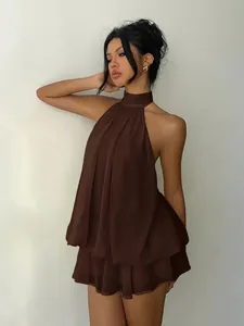 Elegant dark brown halter neck backless pleated mini dress shown on a female model