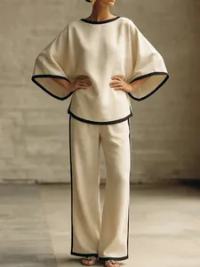 Elegant women's cream cotton linen two-piece set featuring batwing sleeves and black trim.