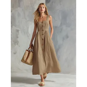 Detailed view of summer button-down sleeveless maxi dress in khaki with straw handbag.