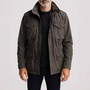 Close-up detail of a vintage olive green M65 field jacket for men featuring functional pockets