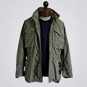 Detailed view of a vintage M65 men's field jacket with classic multi-pocket design