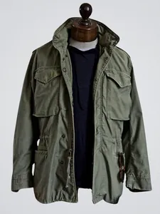 Classic vintage olive green M65 men's military field jacket featuring multiple utility pockets