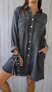 Detailed view of grey oversized denim-style shirt with raw hem and pockets