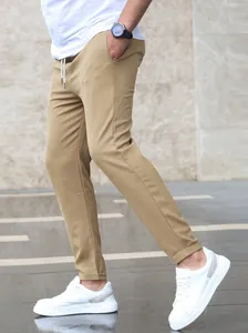 Side view of men's slim-fit khaki joggers with drawstring waist and tapered hem