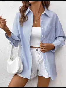 Detailed view of women's blue and white striped long sleeve shirt with classic buttons