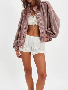 Detailed view of women's pink oversized retro knit cardigan jacket with textured waffle pattern