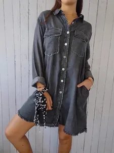 Oversized grey denim shirt dress with frayed hem and chest pockets for a relaxed look.