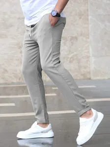 Detailed side view of men's light gray cropped slim-fit joggers with drawstring waist