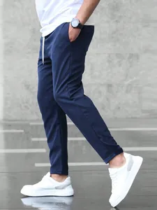 Detailed side view of men's navy blue cropped joggers featuring a slim fit design