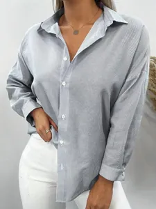 Detailed view of women's blue and white vertical striped long-sleeve button-down shirt.