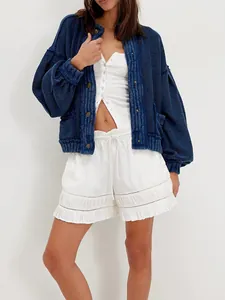 View of the relaxed fit and chunky knit texture of a blue vintage cardigan on a model