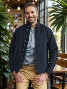 Front view of a men's navy stand collar jacket with zipper detail in a cafe setting.