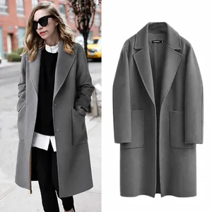 Detail view of grey long-sleeved wool blend overcoat with front pockets and notched lapel