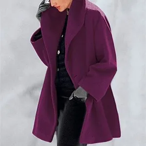 Side detail of a vibrant purple loose fit wool coat for women featuring large lapels