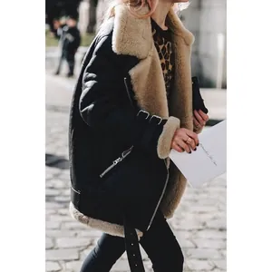 Detailed shot of a black faux suede shearling biker jacket with warm beige lining.