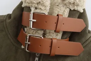 Close-up of double leather straps and buckles on olive green faux suede coat collar.
