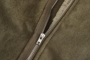 Macro view of metallic zipper and faux suede texture on men's winter shearling coat