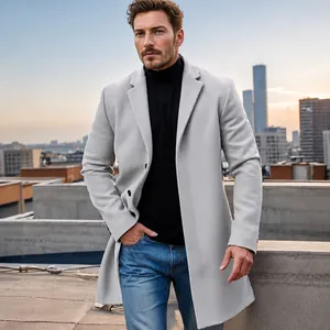 Lifestyle view of a premium light grey wool trench coat for men against a city sunset.