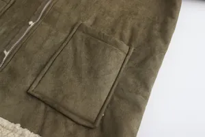 Detail shot of pocket and faux suede texture on men's shearling-lined winter coat.