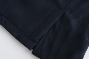 Macro detail of navy suede fabric and precision stitching on men's winter coat