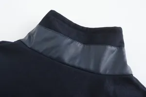 Close-up detail of men's winter coat collar with leather trim and soft fleece texture