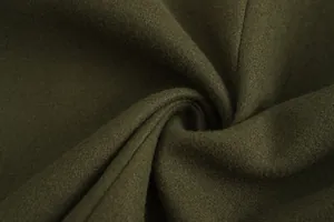 Detailed macro texture of thick dark olive green wool fabric for luxury men's winter coat
