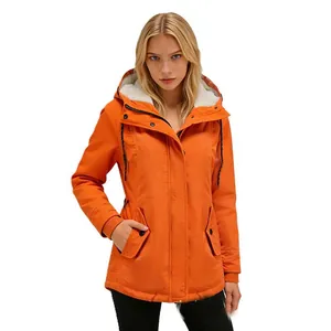 Model wearing a vibrant orange hooded winter parka with soft white fleece lining detail