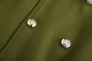 Macro detail of ornate golden embossed crest buttons on premium olive green wool coat