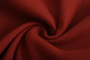 Detailed macro view of premium thick red woolen fabric showing soft texture and depth