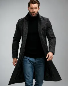 Detailed shot of a men's mid-length charcoal grey wool coat with elegant textured fabric
