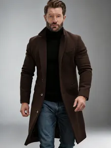 Detail shot of a men's classic dark brown mid-length wool overcoat on a model.