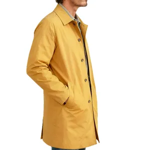 Detailed side view of mustard yellow men's trench coat showing slim fit and buttons