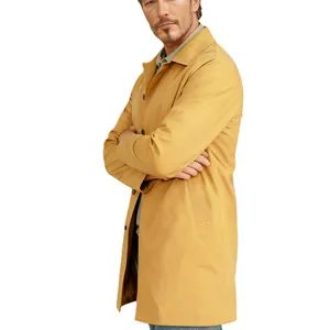 Detail view of a men's mustard yellow trench coat featuring single-breasted buttons and lapel