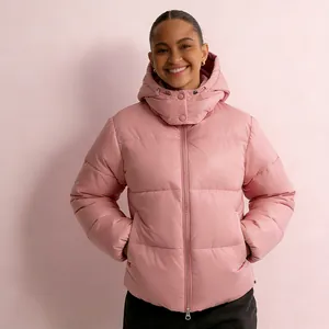 Professional detail view of a pink hooded puffer jacket for women in a studio setting.