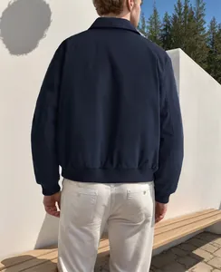 Rear view of a minimalist navy blue men's commuter jacket with a classic turn-down collar.