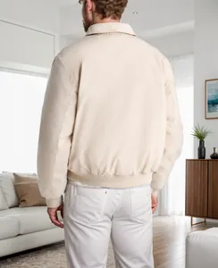 Rear view of a minimalist cream beige men's bomber jacket with ribbed hem and cuffs.