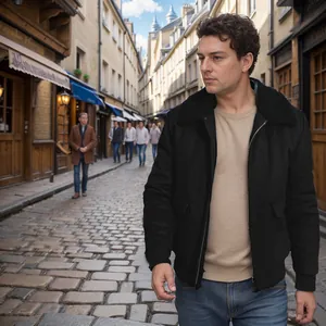 Detail view of men's black wool jacket with faux fur collar in a street setting