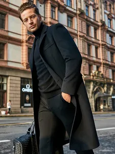 Detailed close-up view of a men's long black wool coat in a classic British urban street.