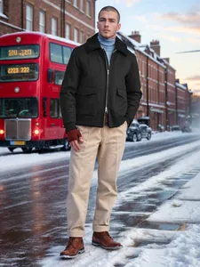 Stylish men's black wool jacket with a warm fleece collar in a snowy winter urban scene