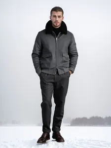 Full-length view of men's grey wool bomber jacket with black fur collar in snow