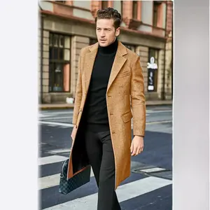 Stylish men's British long wool coat in camel worn by a model walking in the city street.