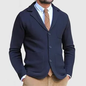 Close-up of a men's slim-fit navy knitted blazer with three buttons and patch pockets.
