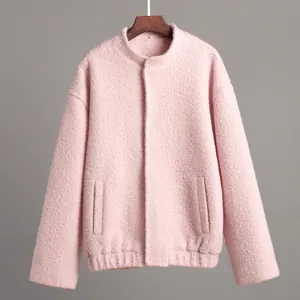 Detailed view of women's pink fuzzy fleece jacket featuring stand collar and side pockets