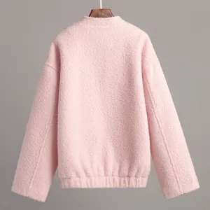 Back view of a soft pink textured fleece jacket for women featuring an elasticated hem