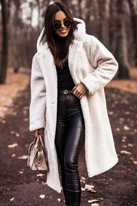 Detailed view of women's long white hooded teddy coat with warm plush texture