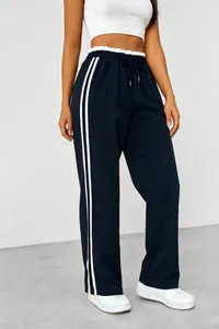 Detail view of navy blue high-waisted sweatpants with white side stripes and drawstring